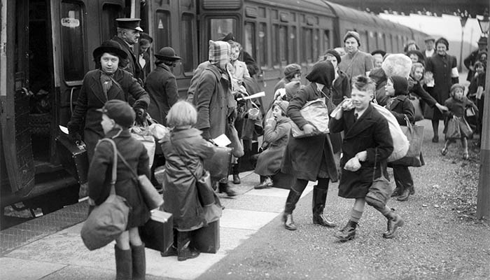 World War II evacuees boarding a train.