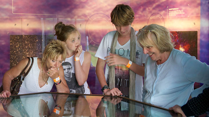 People enjoying an exhibition at Jodrell Bank.