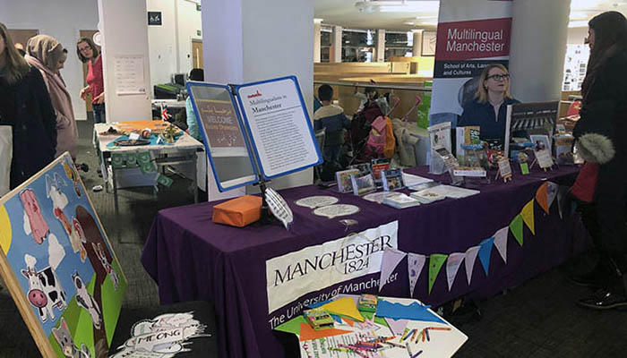 The Multilingual Manchester stand at an event.