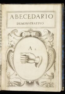 Illustrated page showing a closed fist, the hand-sign for the letter 'A', under the heading Abecedario